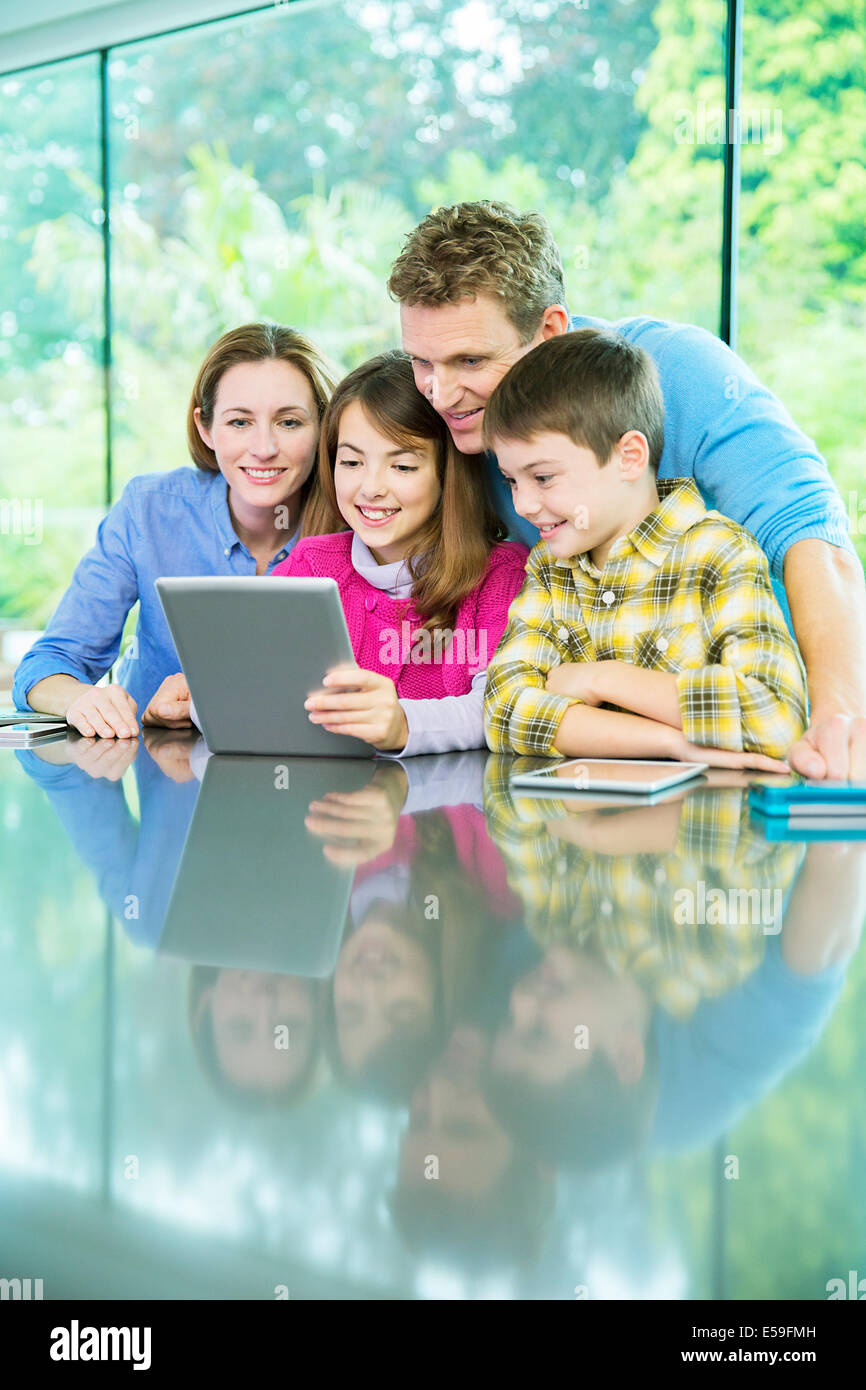 Family using digital tablet together Stock Photo - Alamy