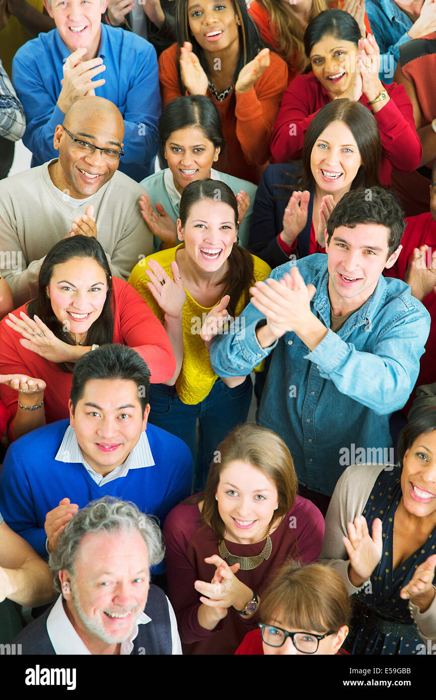 Portrait of happy crowd clapping Stock Photo