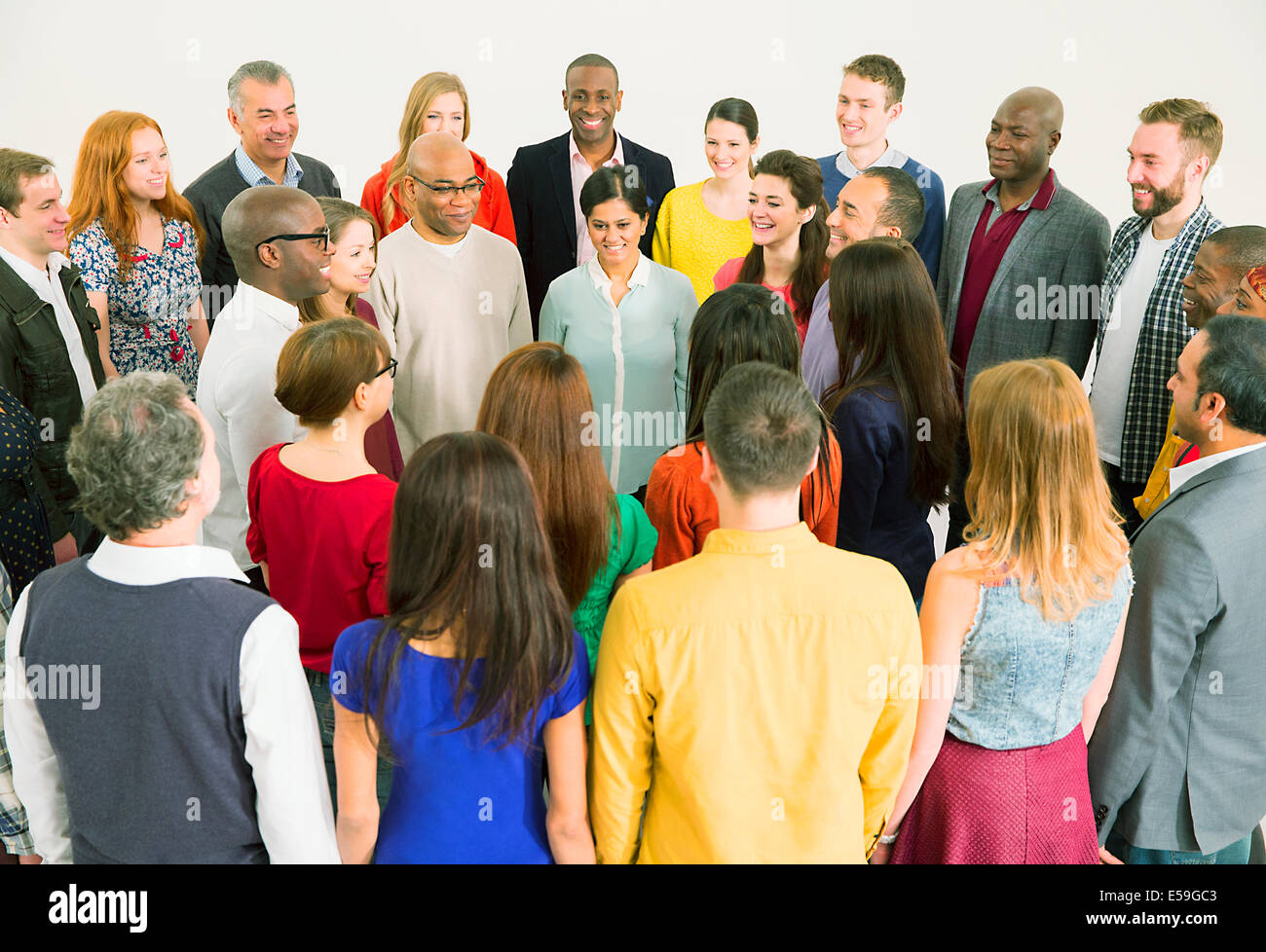 Diverse crowd meeting in circle Stock Photo