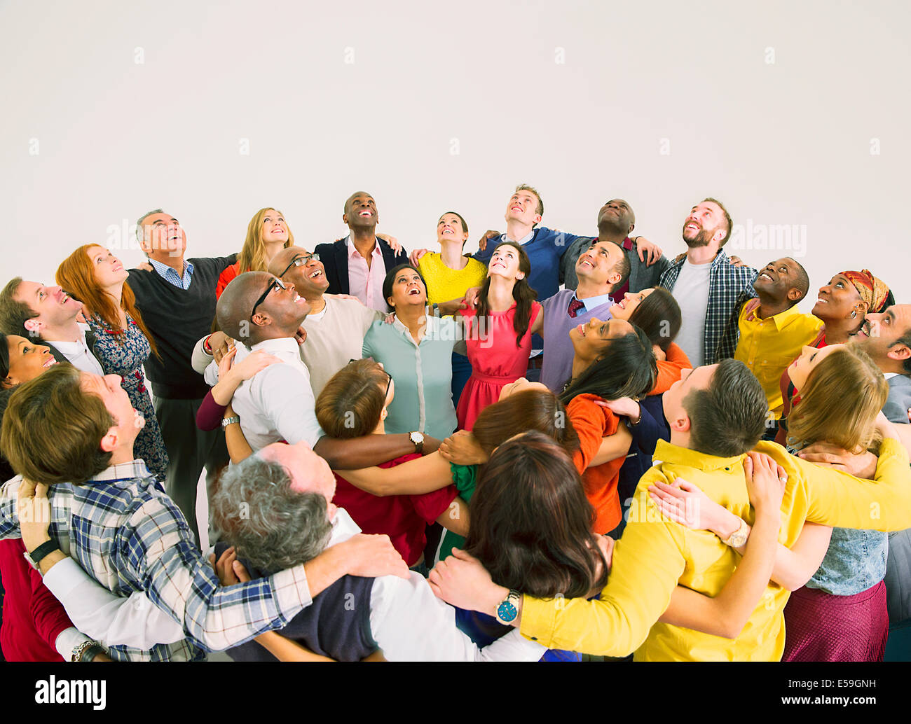 Diverse crowd in huddle Stock Photo