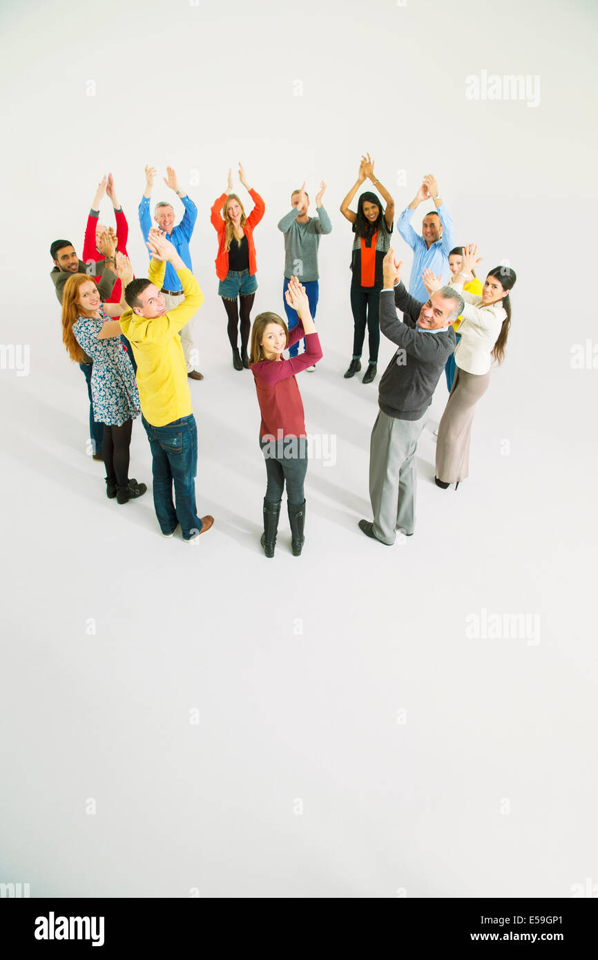 Clapping business people in circle Stock Photo