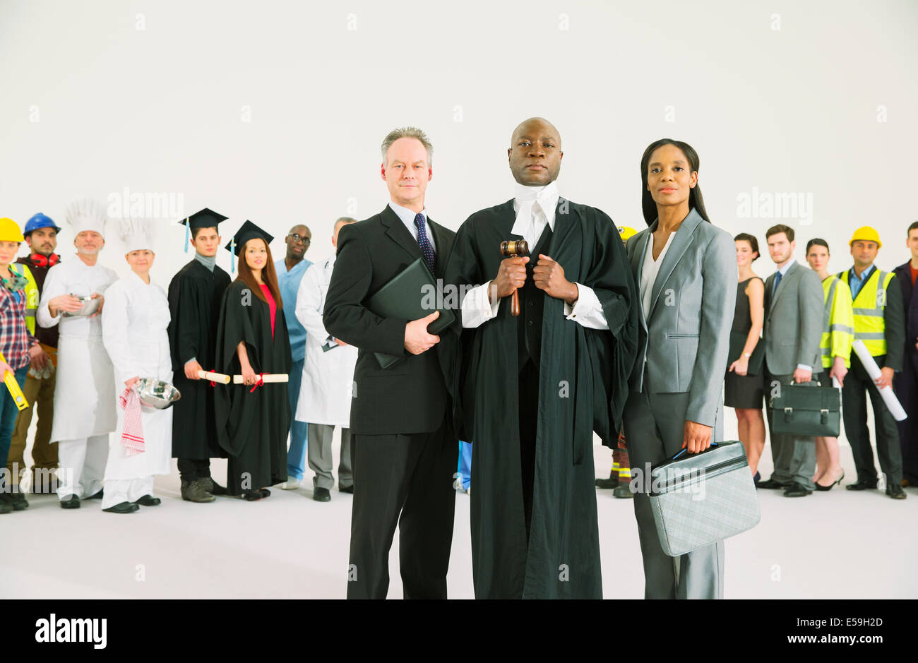 Workforce behind confident lawyers and judge Stock Photo