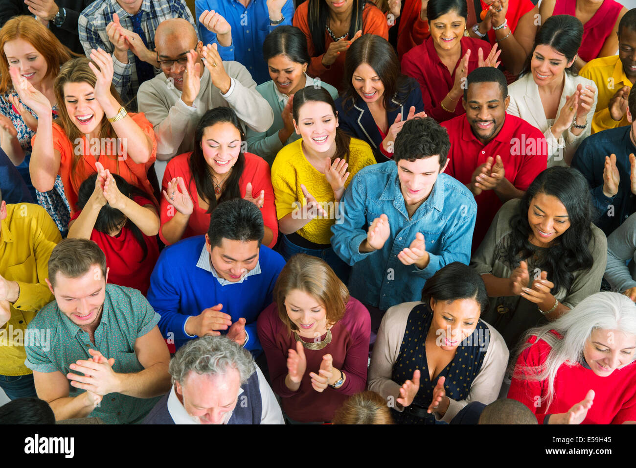 Diverse crowd clapping Stock Photo