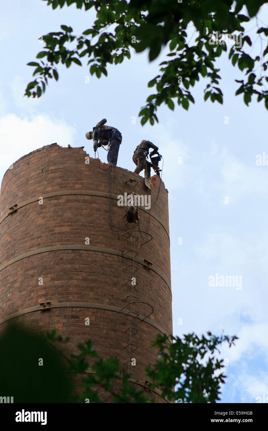 Two workers during old chimney demolition. Cieszyn, Poland. Stock Photo