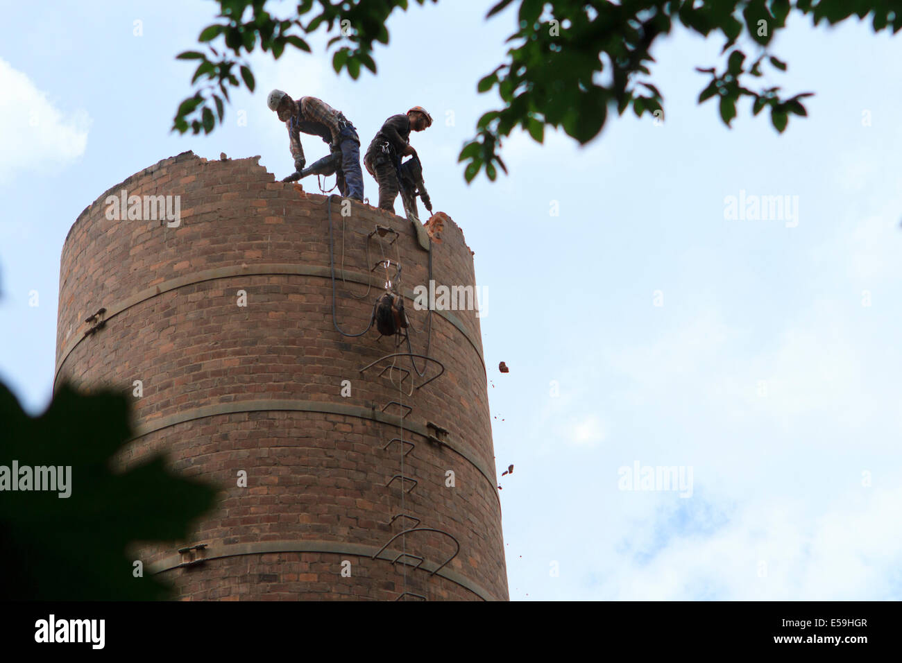 Two workers during old chimney demolition. Cieszyn, Poland. Stock Photo