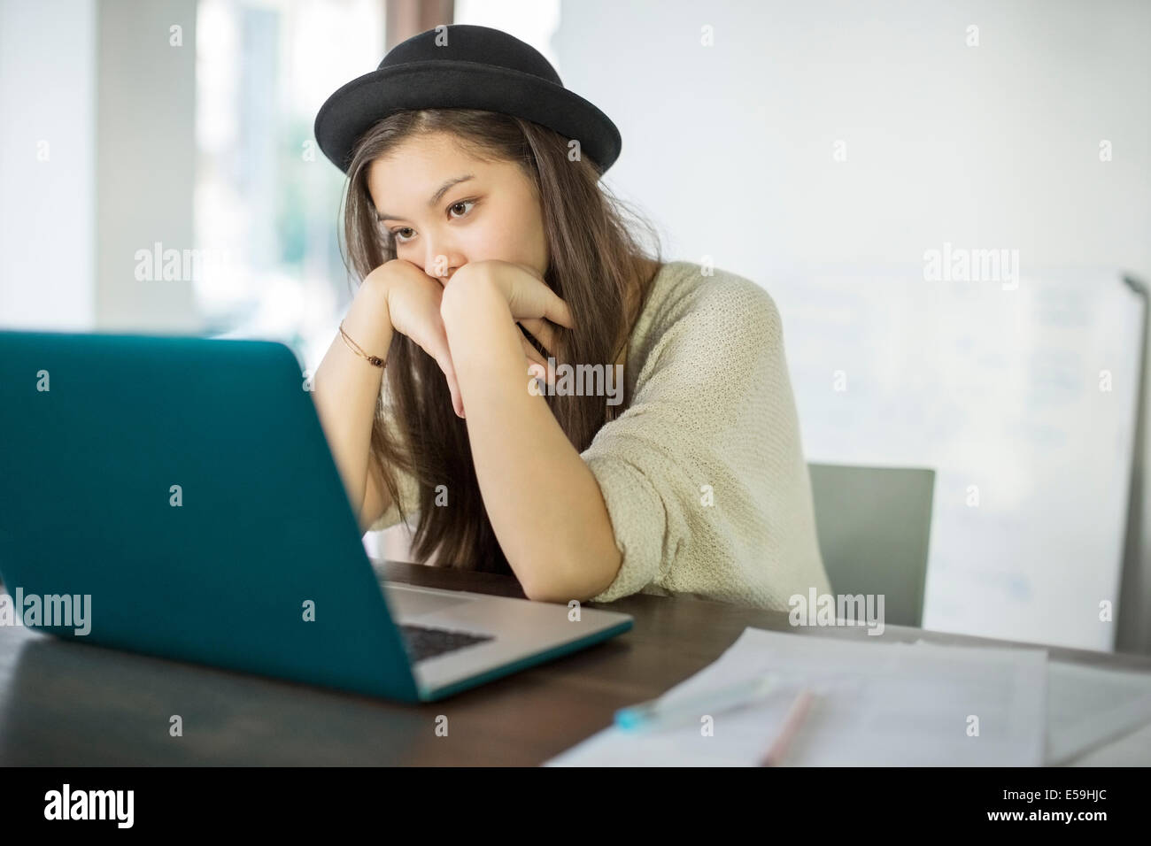Woman working at laptop in office Stock Photo