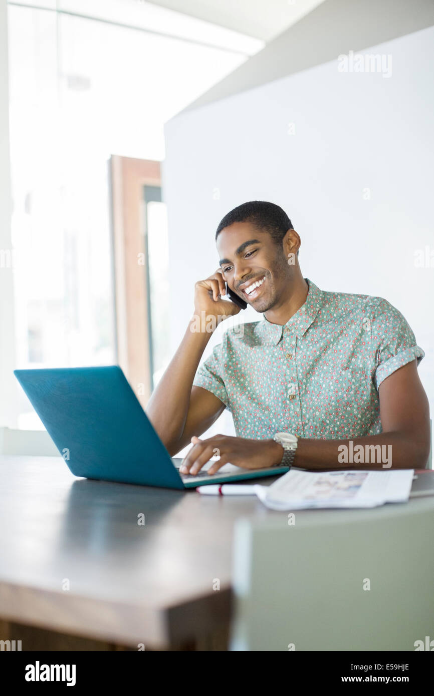 Man talking on cell phone in office Stock Photo