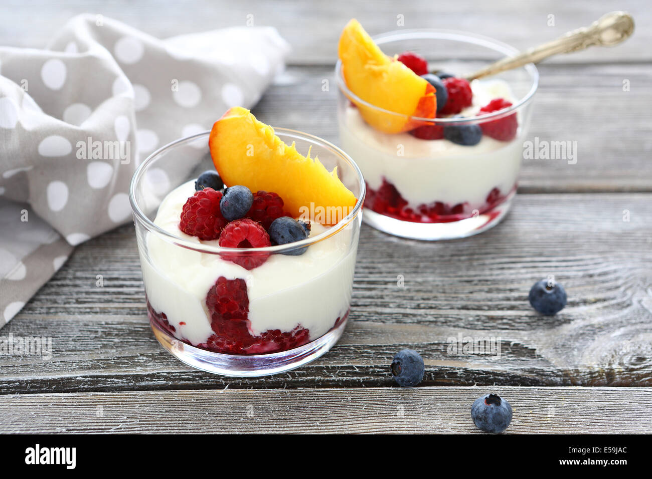 yogurt with fresh berries and peaches, food closeup Stock Photo