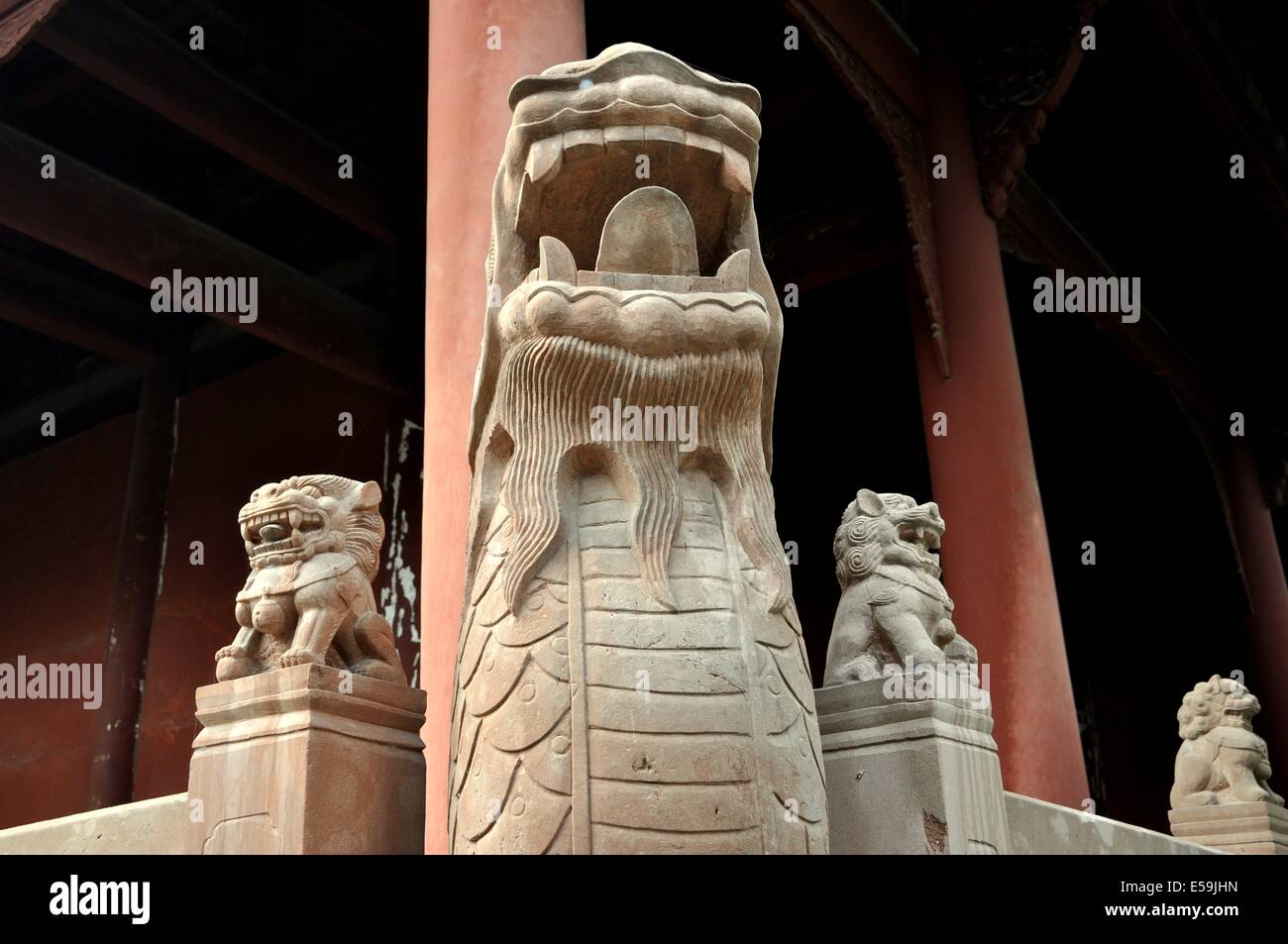 DEYANG, CHINA:  Fu Dog figures stand atop columns surrounding c. 1849 Dacheng Hall at the historic Deyang Confucian Temple Stock Photo