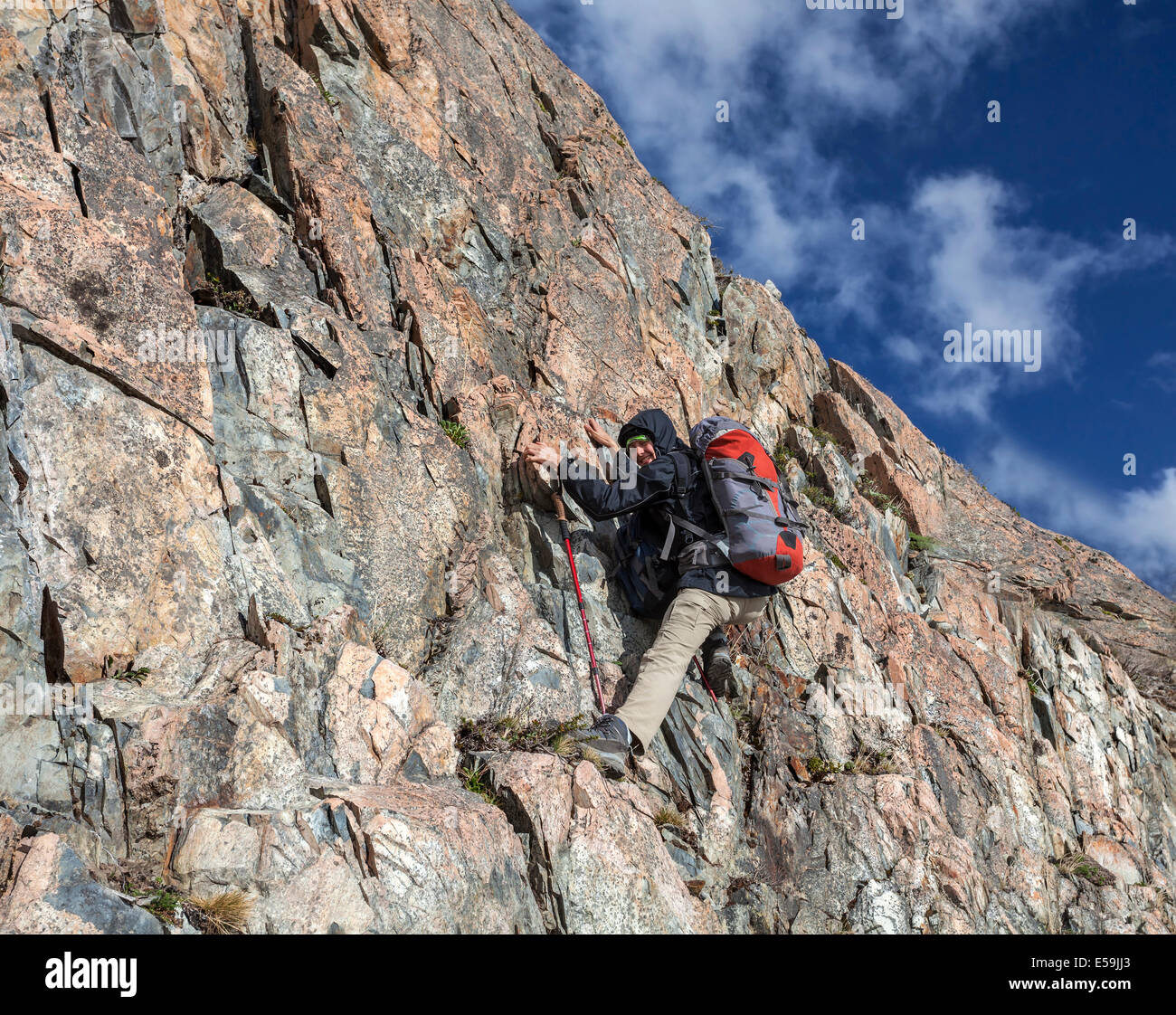 Female hiker climbing with backpack Stock Photo