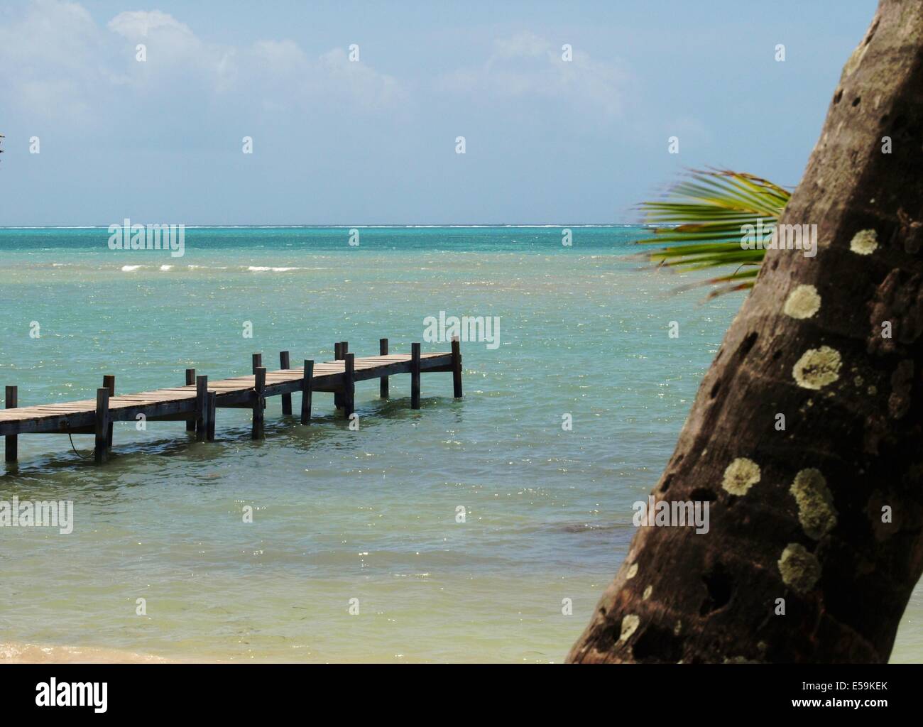 A dock and the beautiful water of Ambergris Caye, Belize Stock Photo
