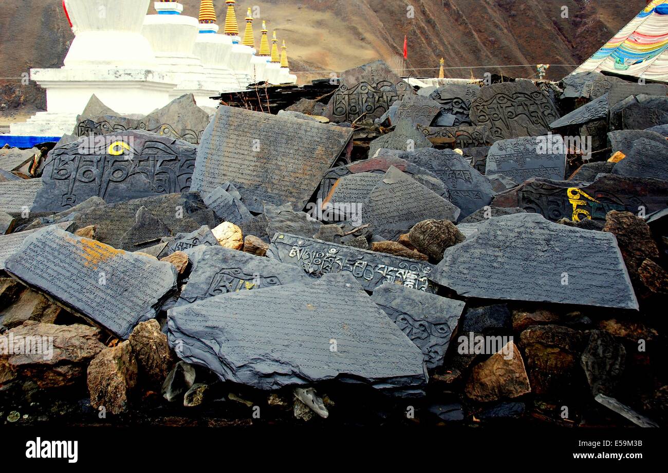 GAN ZI ,CHINA:  Traditional Tibetan prayers are inscribed on broken pieces of slate * Stock Photo