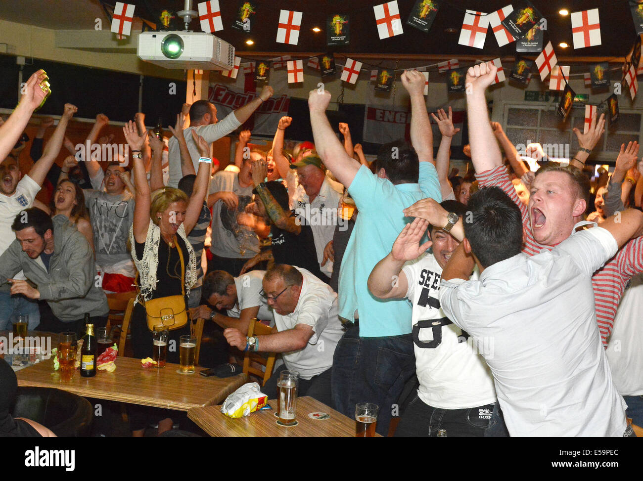 England football fans celebrate an England goal whist watching a world cup match against Italy in the Boomerangs bar,Plymouth Stock Photo