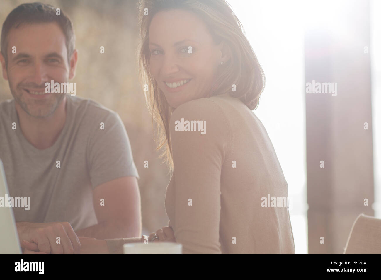 Couple smiling at breakfast table Stock Photo