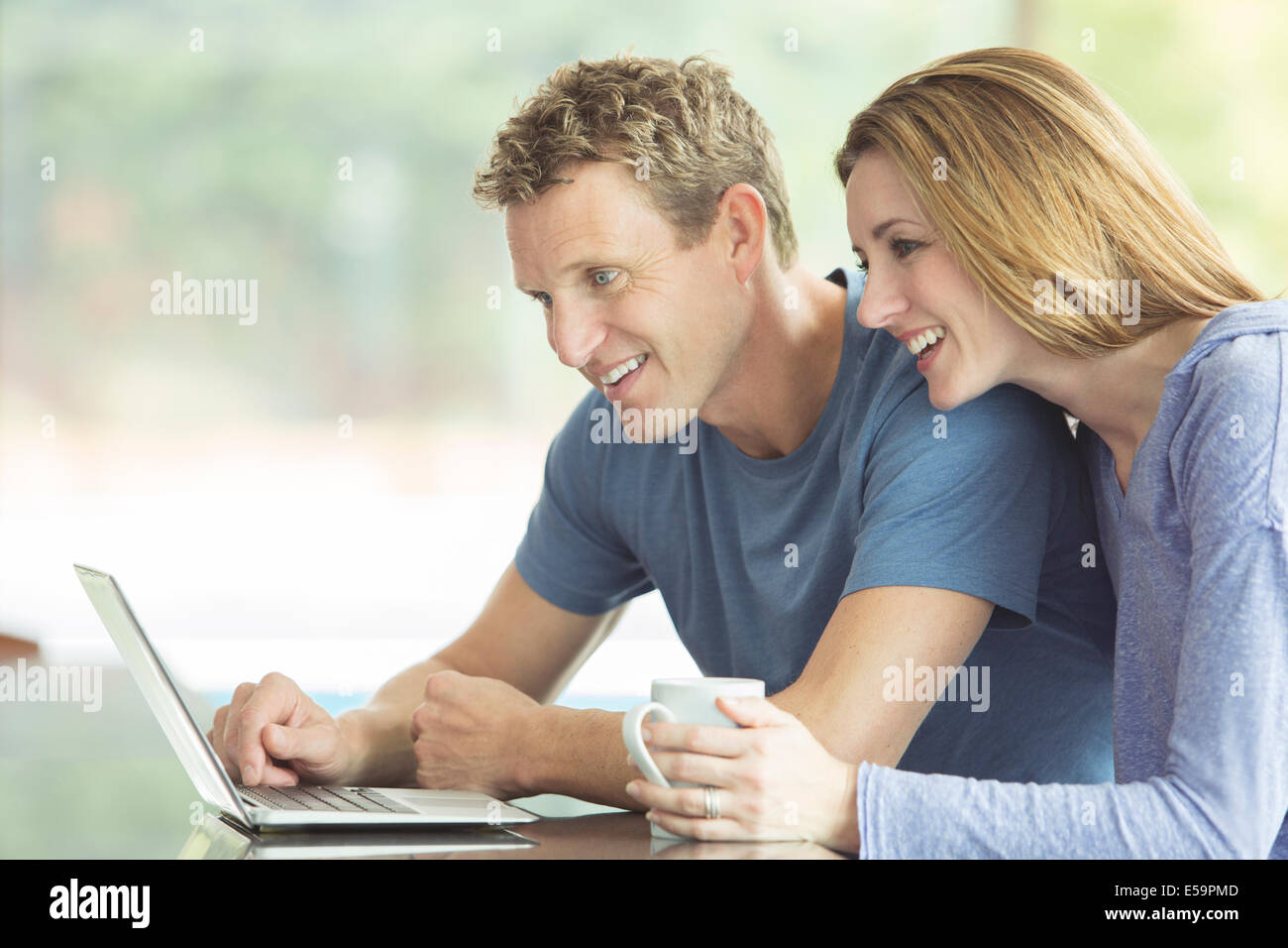 Couple using laptop together Stock Photo