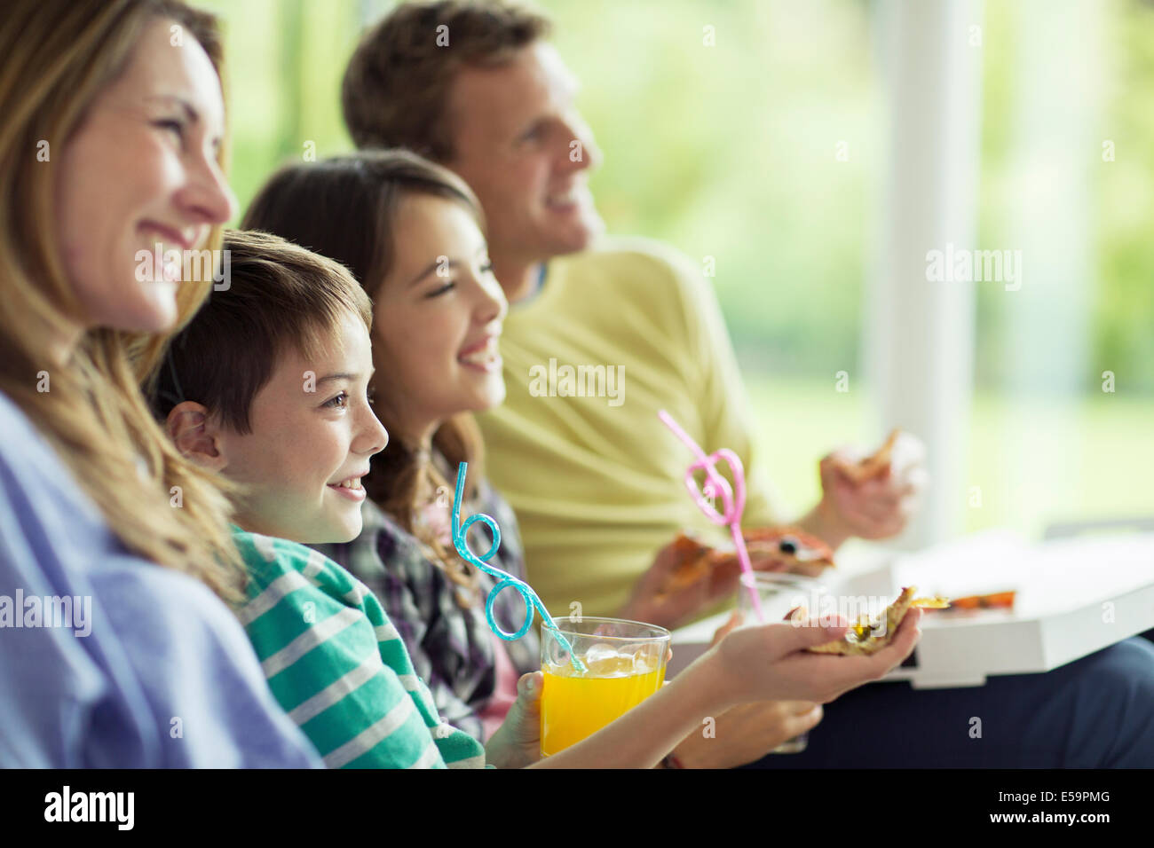 Family watching television in living room Stock Photo