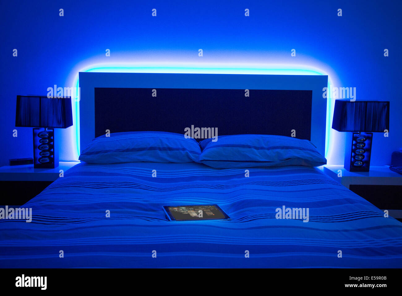 digital tablet on glowing bed Stock Photo