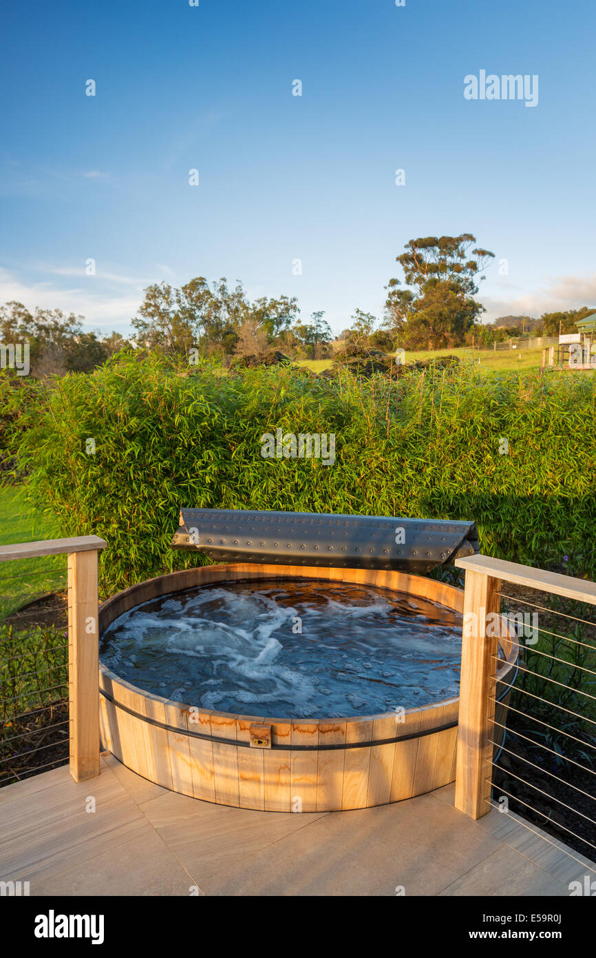 Beautiful wooden hot tub jacuzzi outdoors on deck Stock Photo
