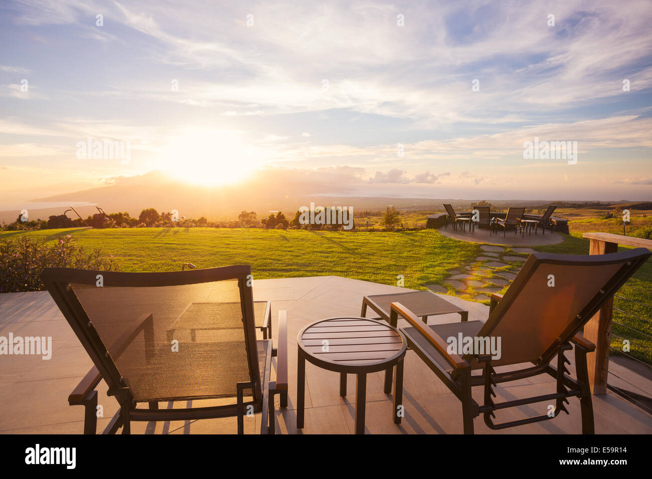 Lounge chairs on deck at sunset Stock Photo