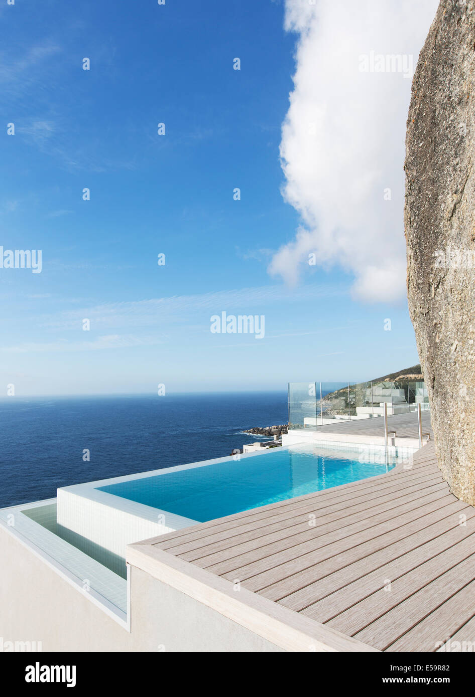 Modern swimming pool overlooking ocean Stock Photo