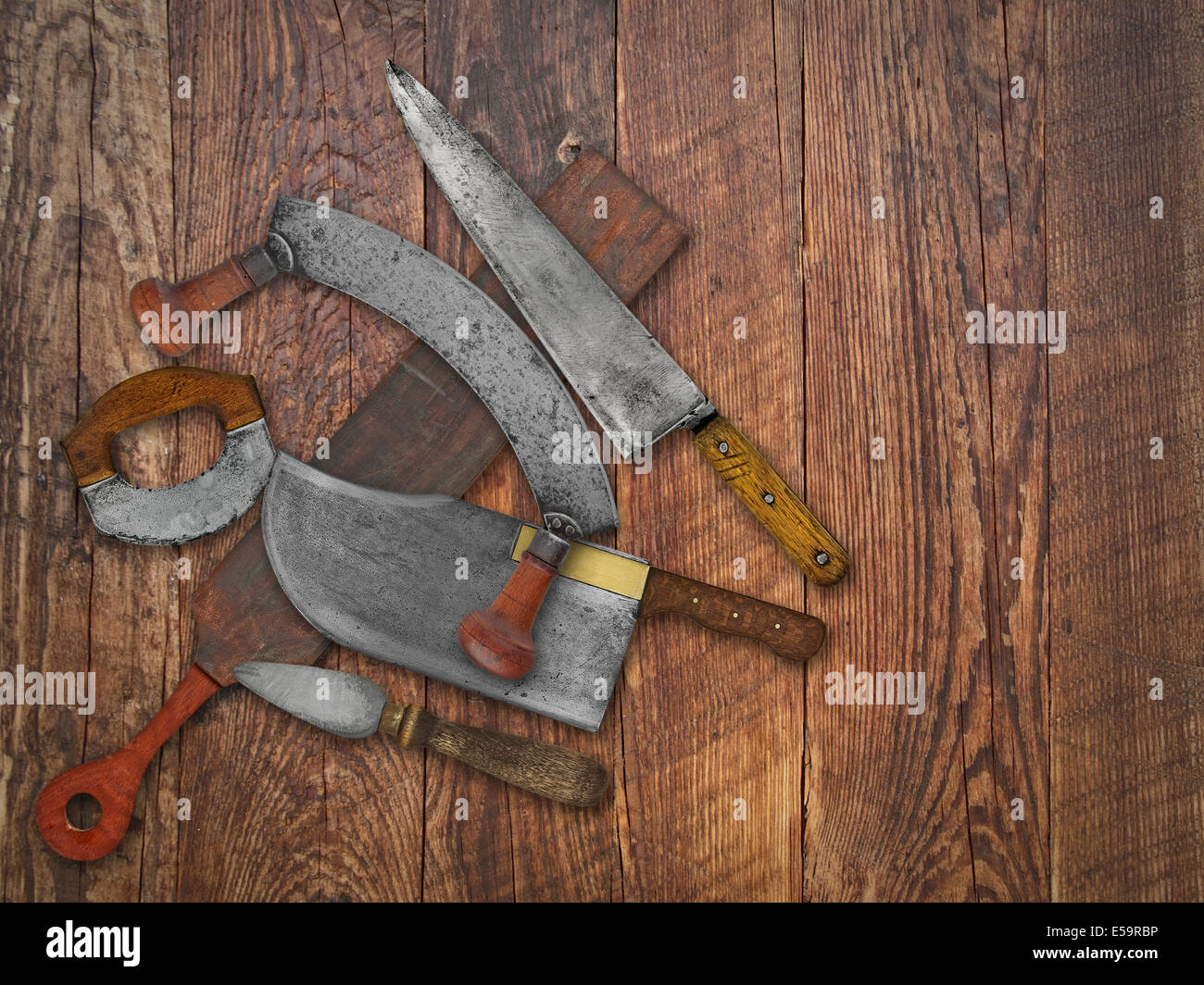 vintage kitchen knives and sharpening tools collage over old wooden table, space for your text Stock Photo