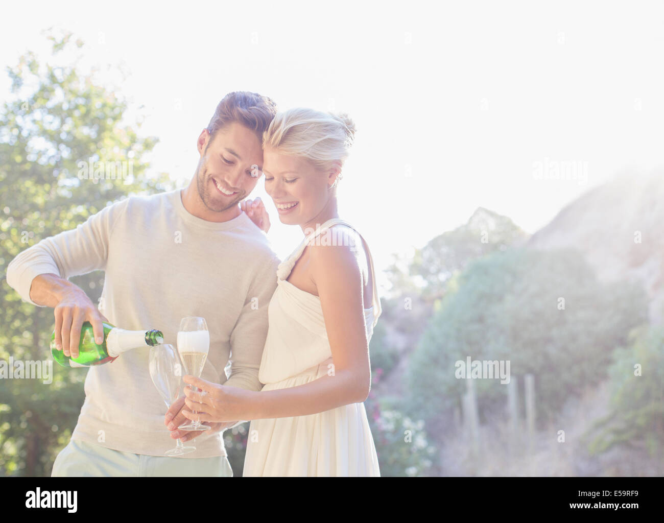 Couple drinking champagne outdoors Stock Photo