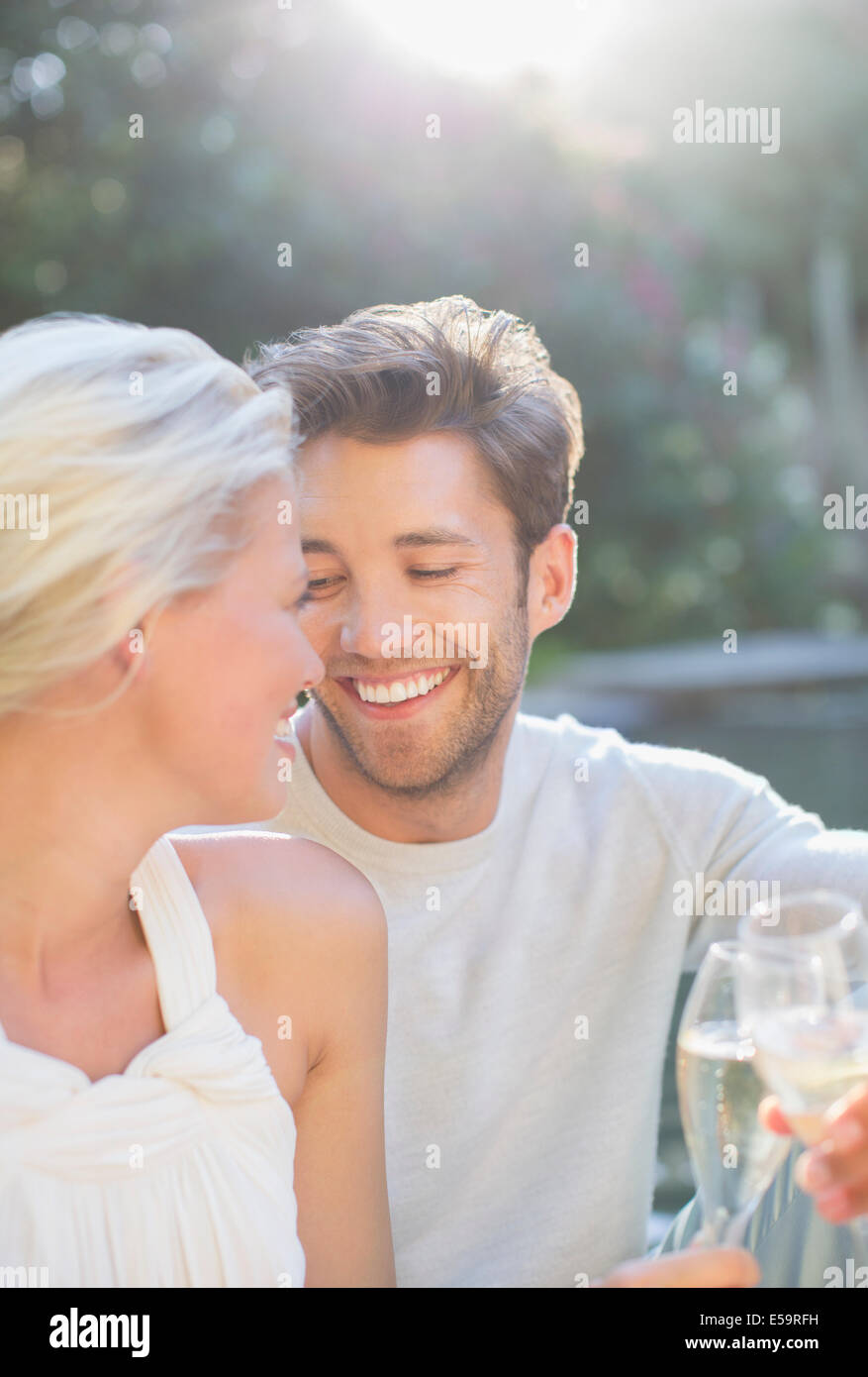 Couple toasting each other with champagne together outdoors Stock Photo