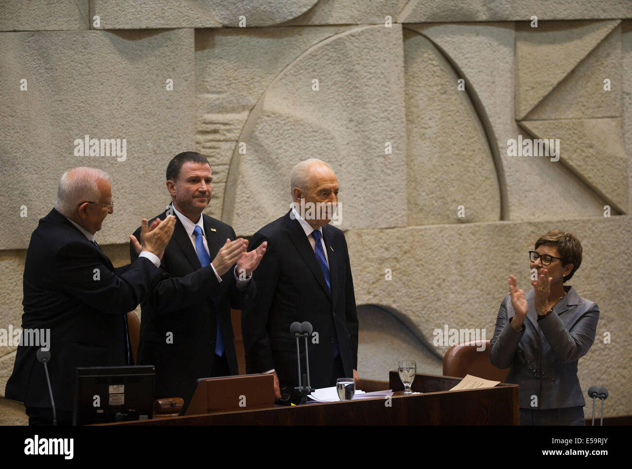 (140724) -- JERUSALEM, July 24, 2014 (Xinhua) -- Outgoing Israeli President Shimon Peres (C) receives respects during Reuven Rivlin (1st L)'s swearing-in ceremony at the Knesset (Israeli parliament) in Jerusalem, on July 24, 2014. Israeli lawmaker Reuven Rivlin was sworn in as the tenth president of Israel on Thursday evening, stepping in the role filled by Shimon Peres for the past seven years.  (Xinhua/POOL/Ronen Zvulun) Stock Photo