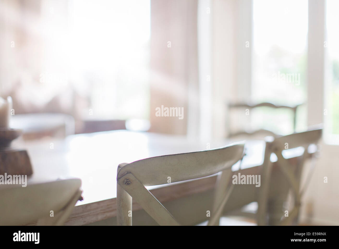 Close up of chairs at dining room table Stock Photo