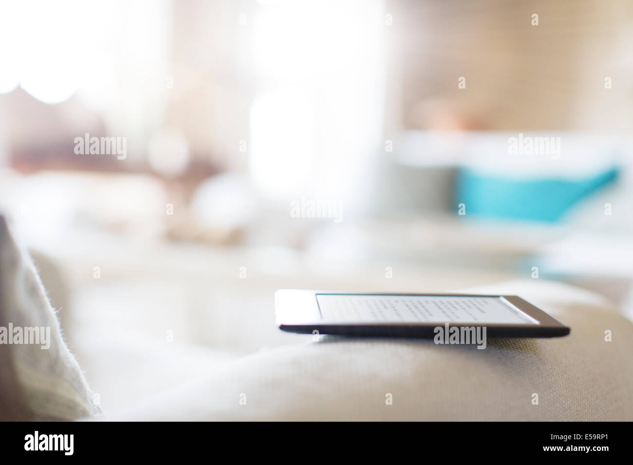 Tablet reader on sofa Stock Photo