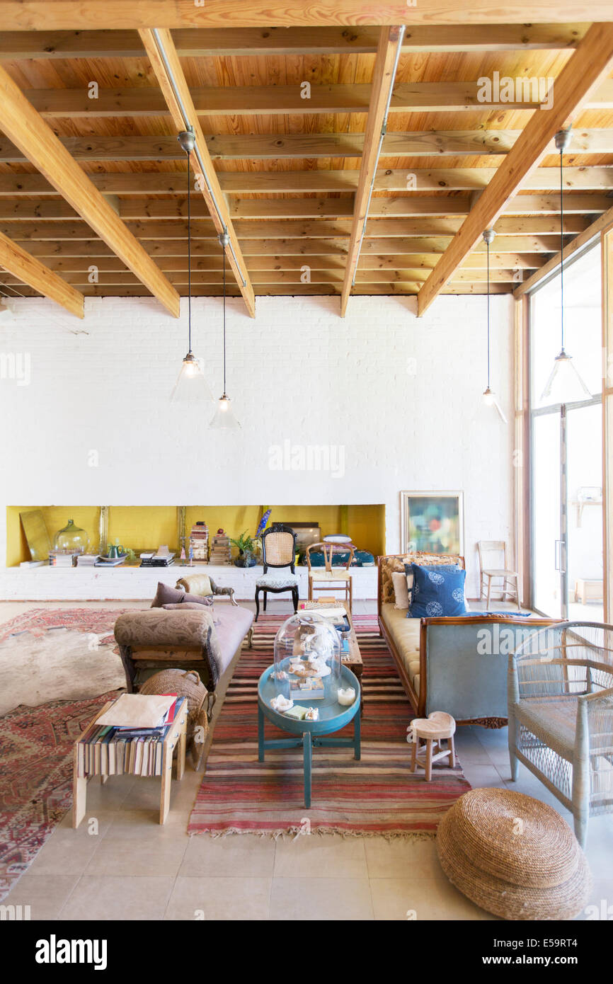 Sofas and coffee tables in rustic living room Stock Photo - Alamy