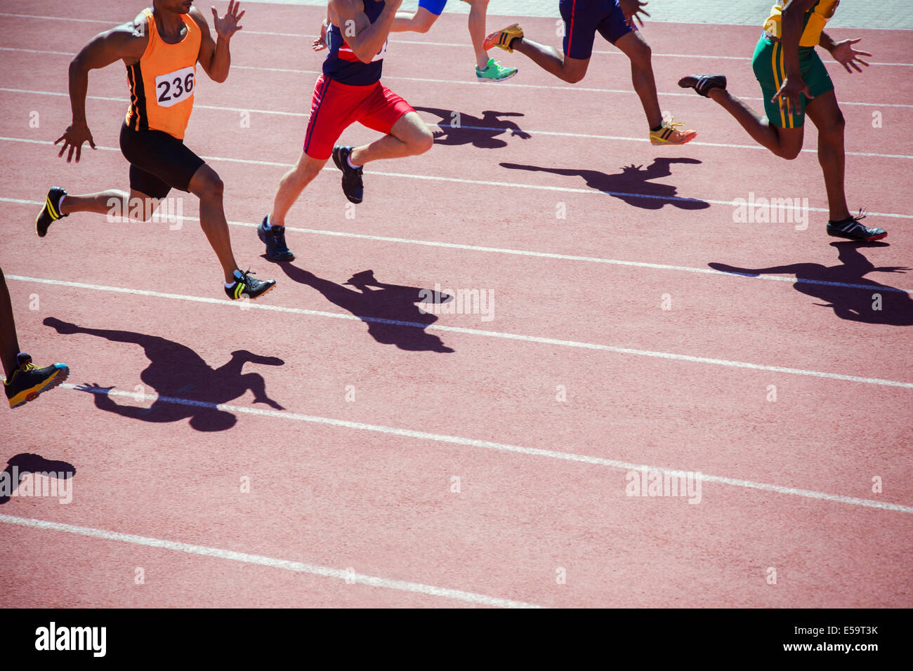 Runners racing on track Stock Photo