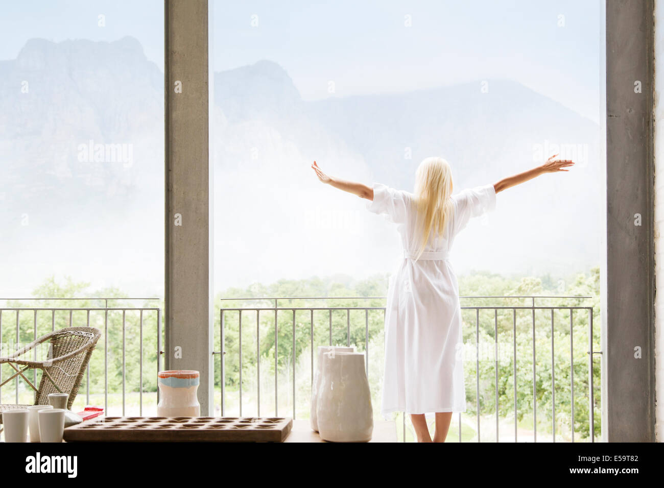 Woman in bathrobe overlooking landscape Stock Photo