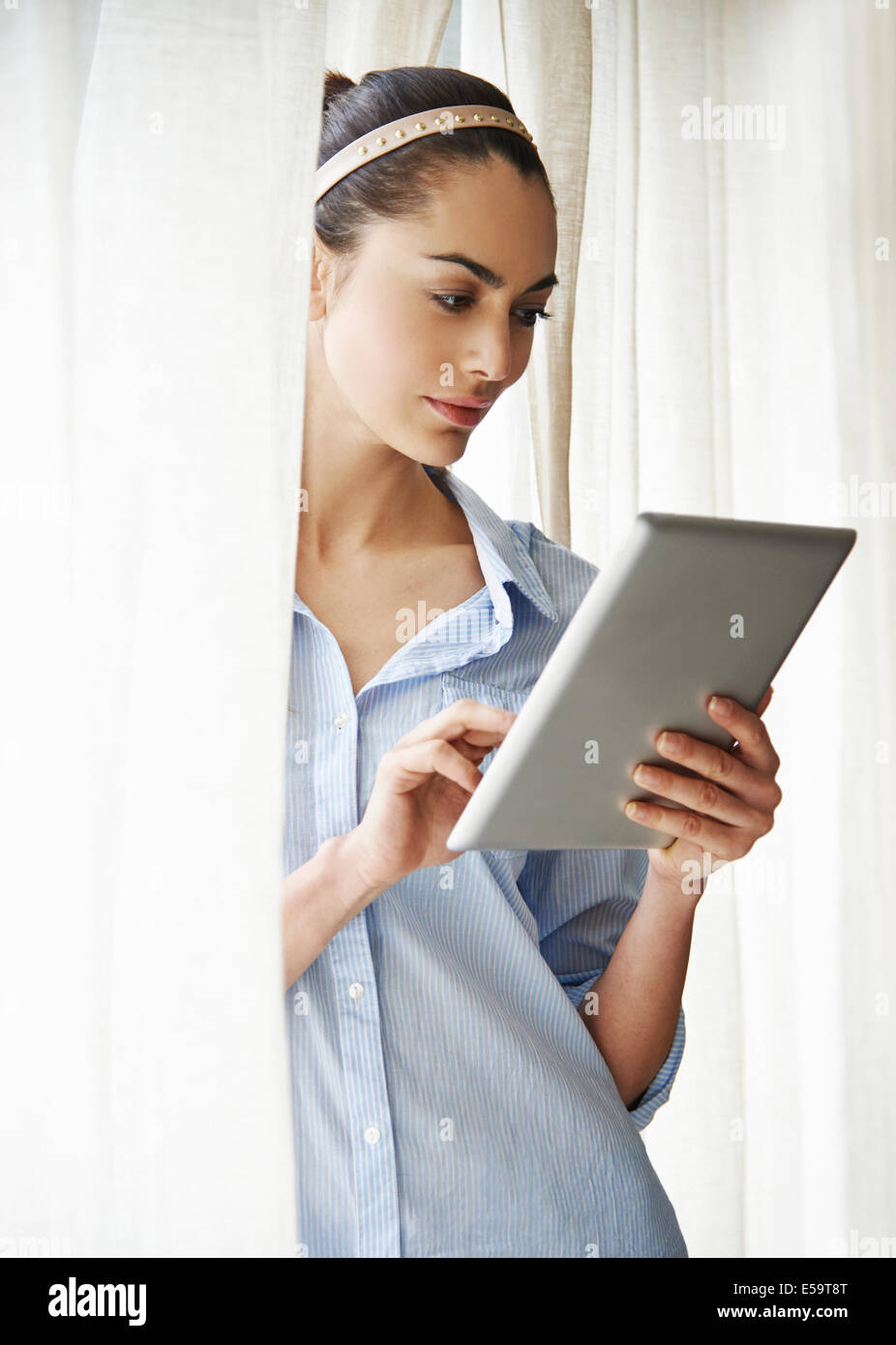Woman standing up using tablet hi-res stock photography and images - Alamy
