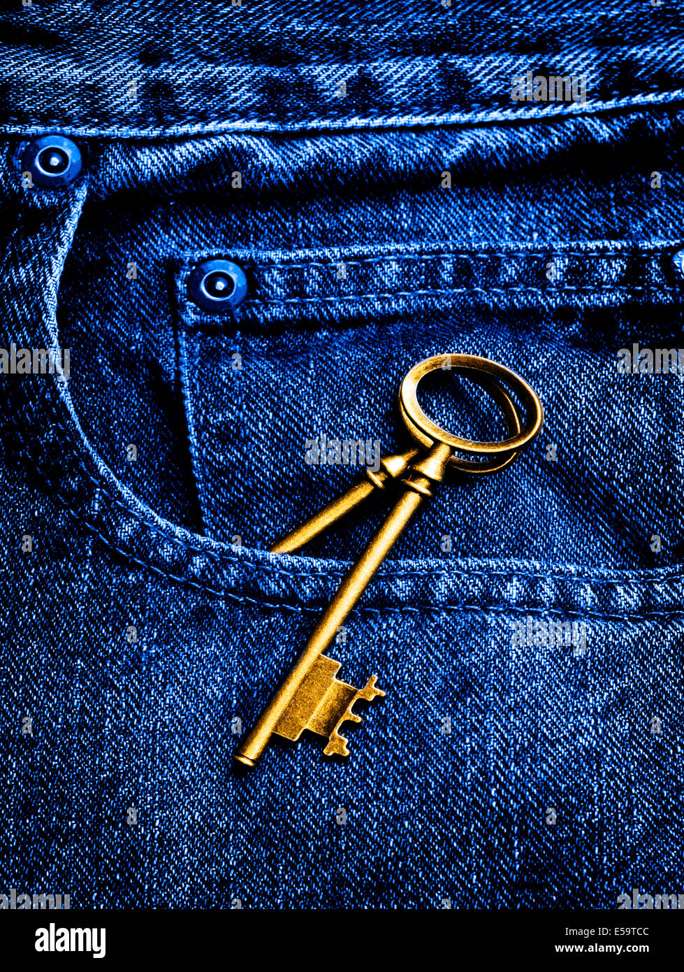 Old jeans with an antique key in pocket Stock Photo