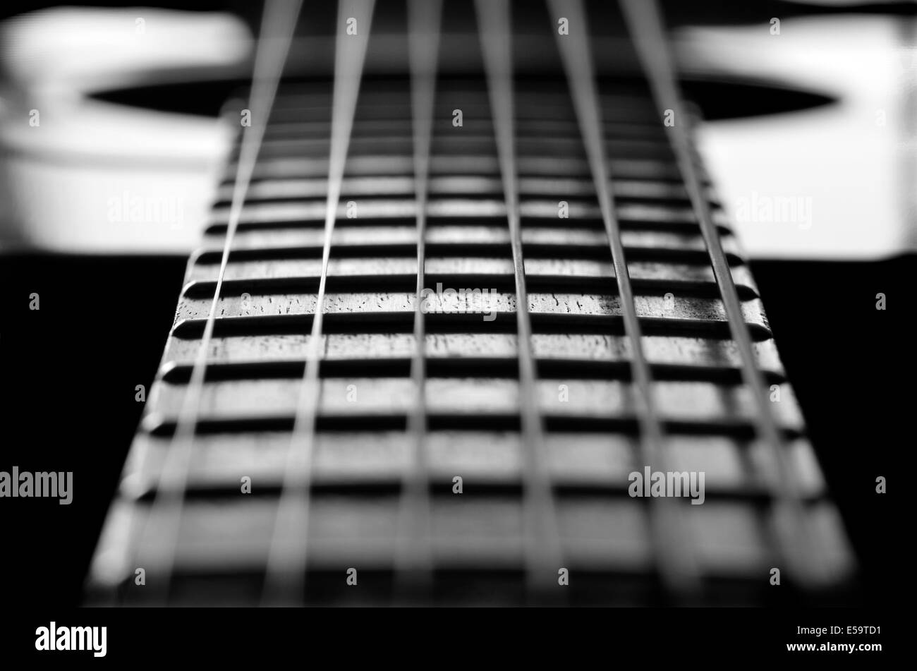 Closeup detail of steel guitar strings and frets for making music Stock