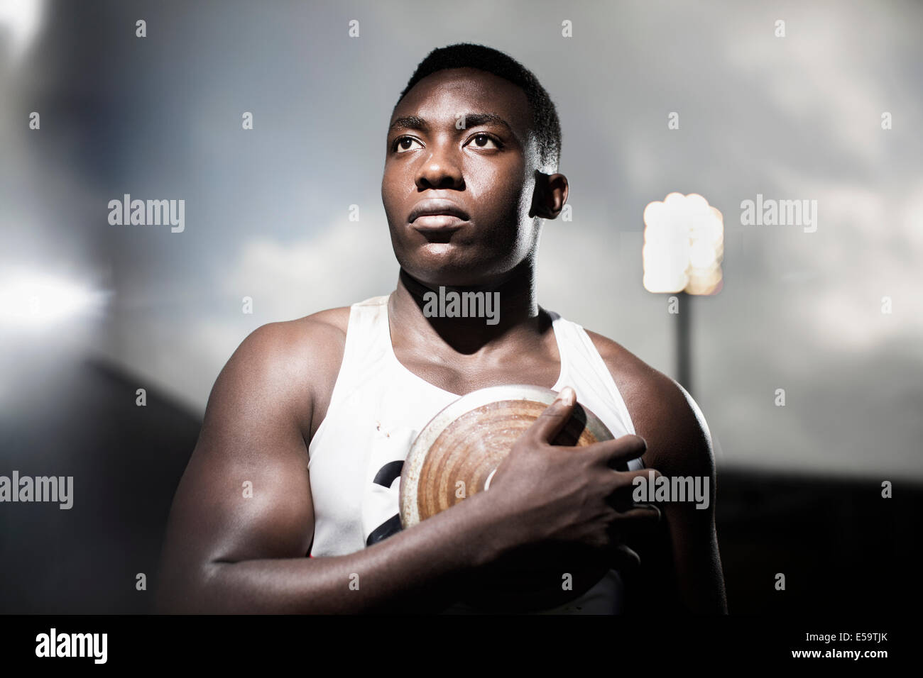 Track and field athlete holding discus Stock Photo Alamy