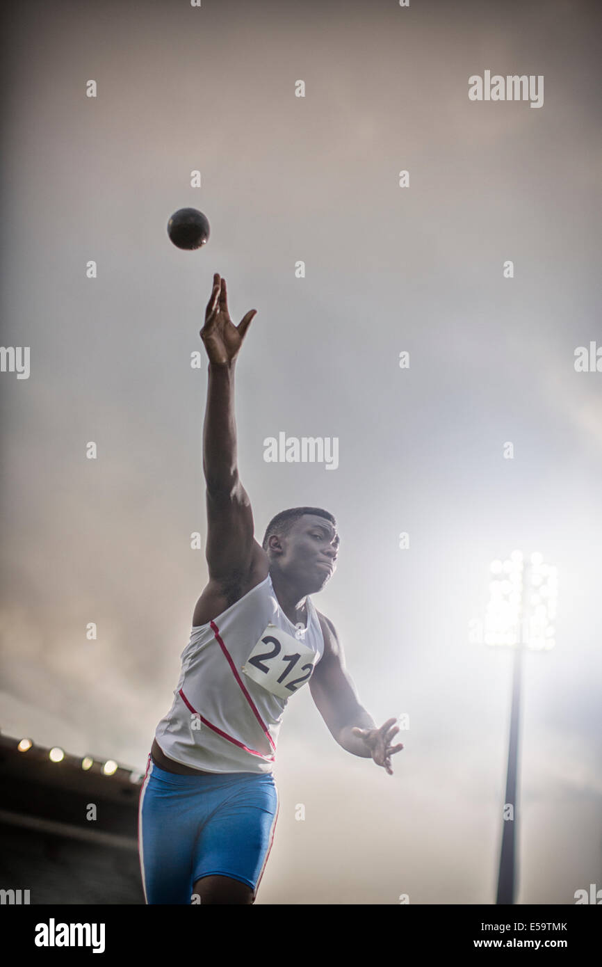 Track and field athlete throwing shot put Stock Photo