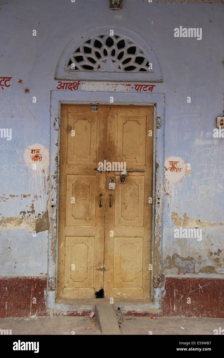 India. Rajasthan. Elaborate  village door structure. Wood , plaster and stone. Natural colours. Blue stained plaster. Stock Photo