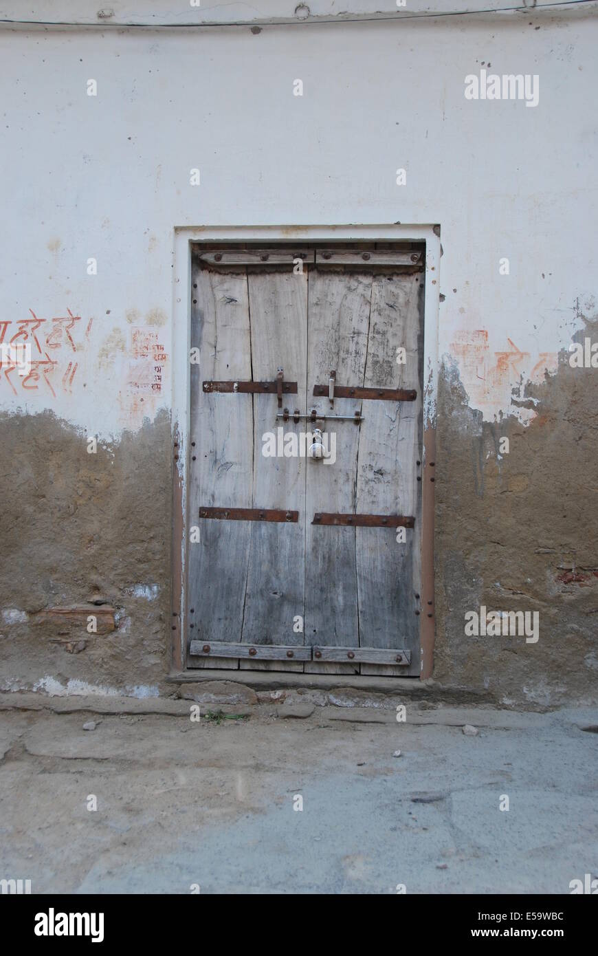 India. Rajasthan. Simple village door structure. Wood , plaster and stone. Natural colours. Stock Photo