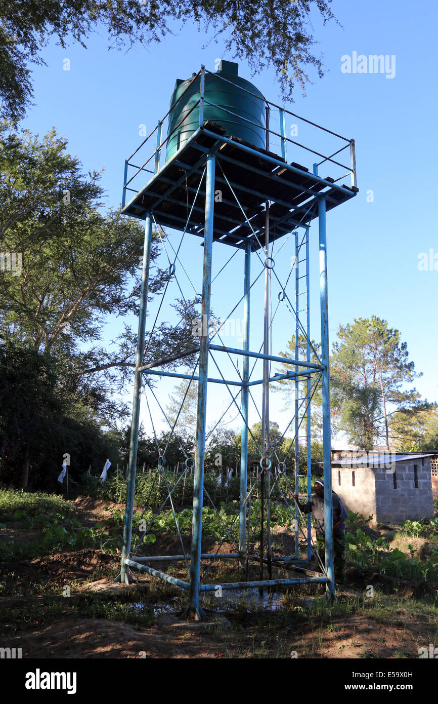 Water tank on a stand in a garden of a farm in Zambia, Africa Stock
