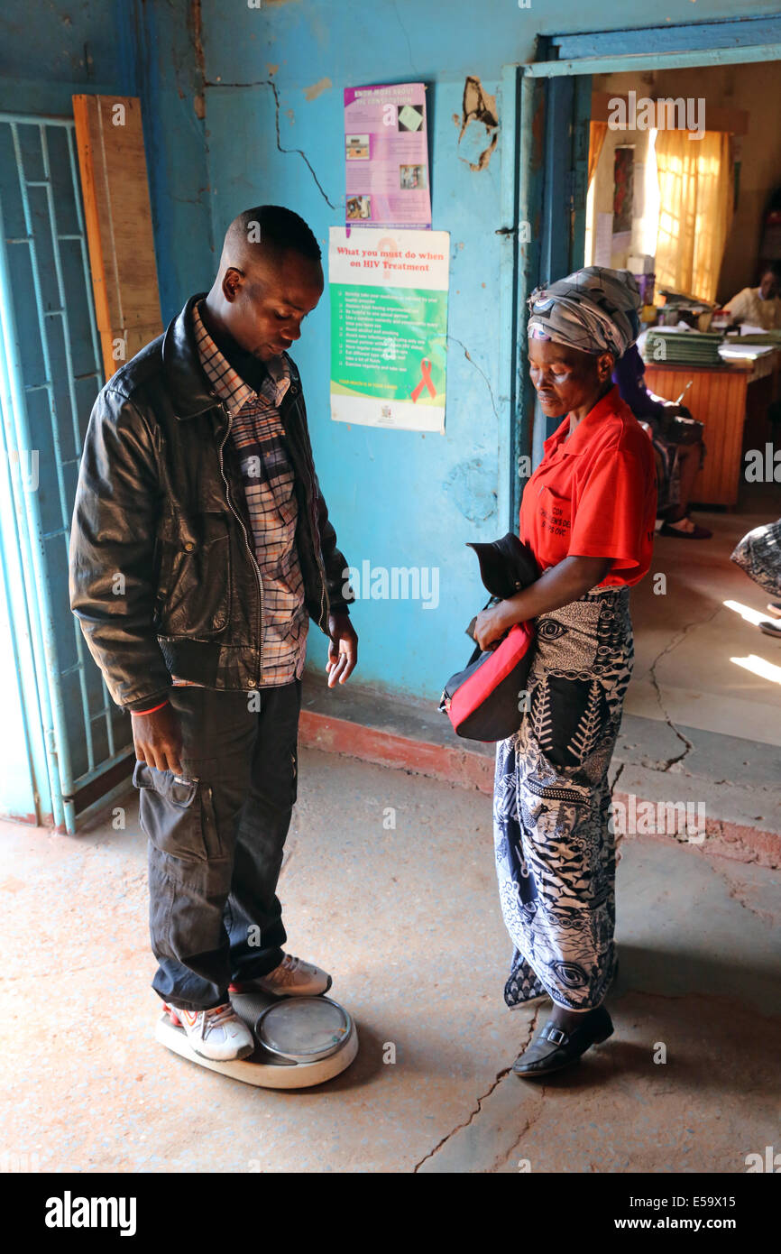 Man infected with HIV AIDS being checked by a health worker to receive ...