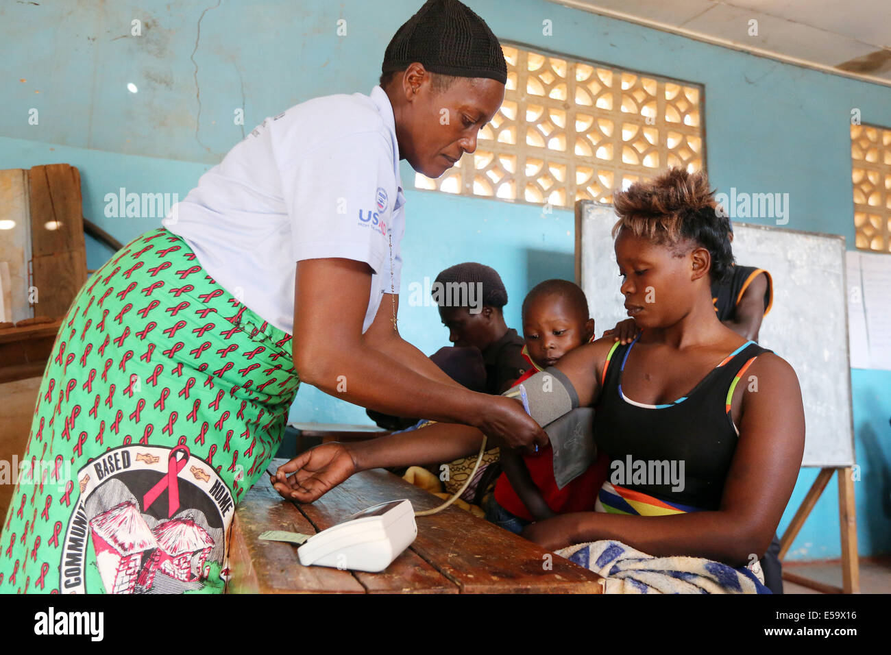 Women infected with HIV AIDS being checked by a health worker to