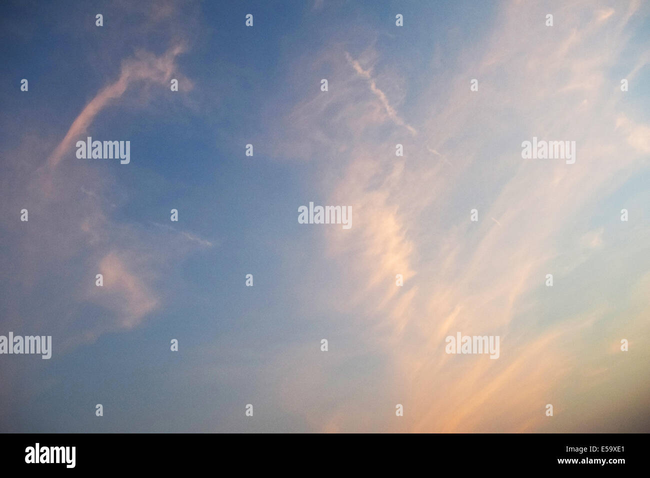 View of the summer evening sky with come lingering clouds Stock Photo