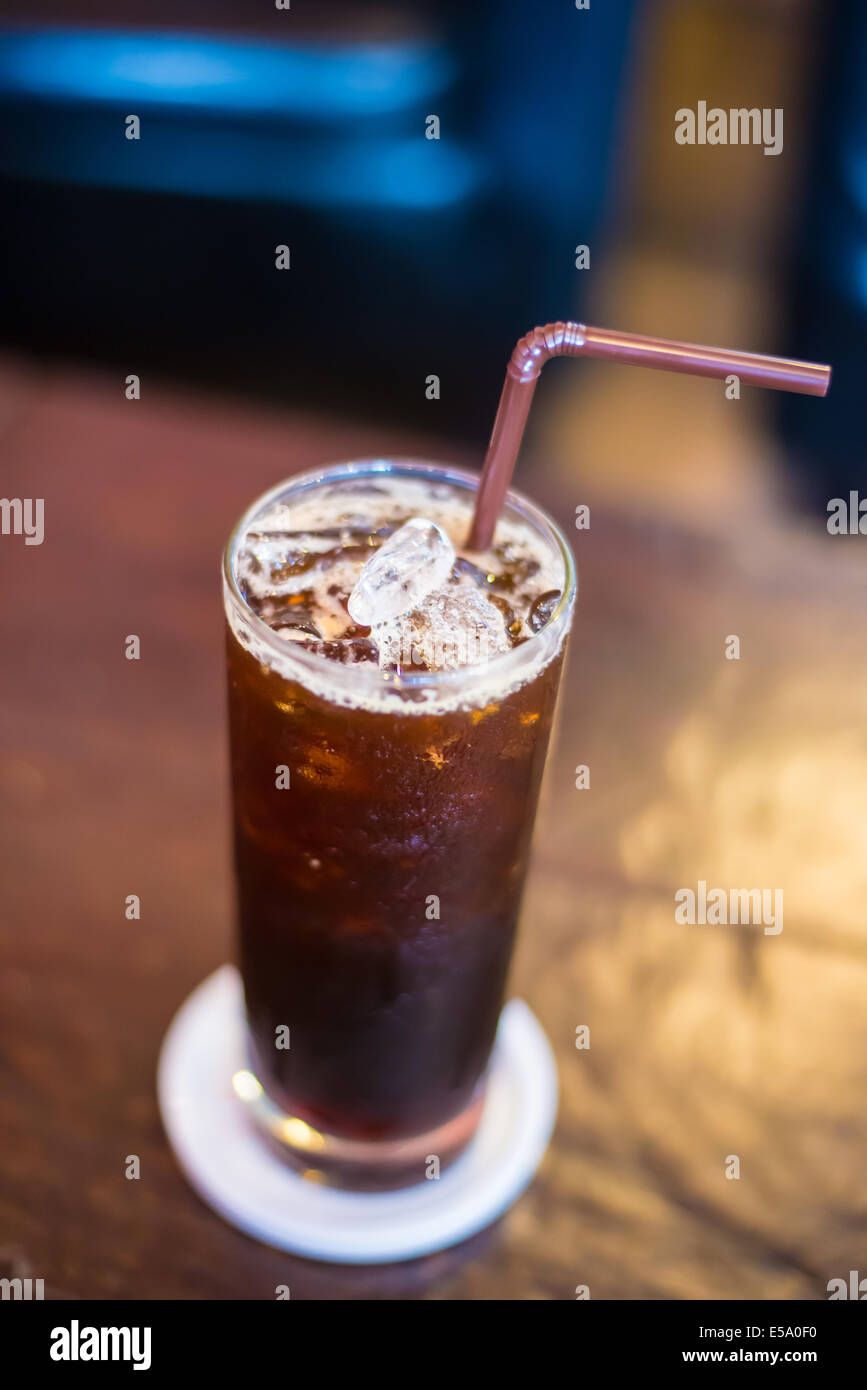 Ice black Coffee on the wooden table in the cafe. Stock Photo