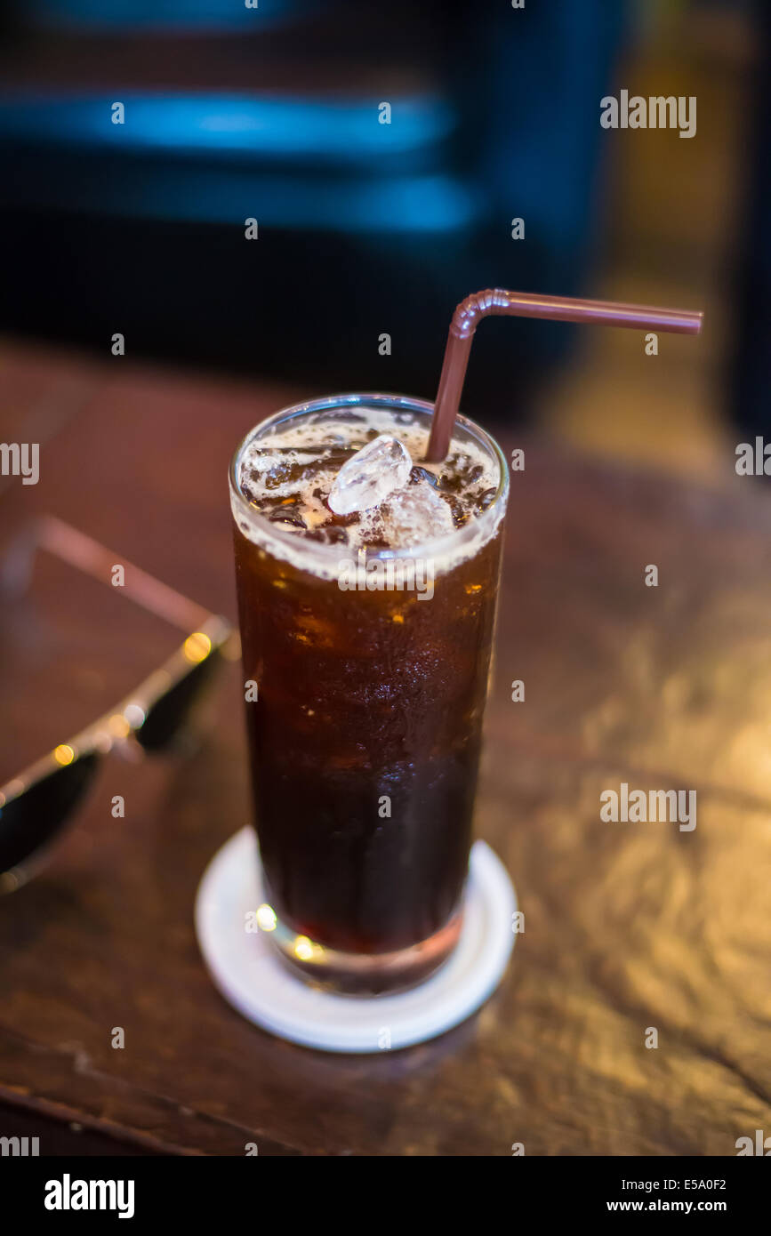 Ice black Coffee on the wooden table in the cafe. Stock Photo