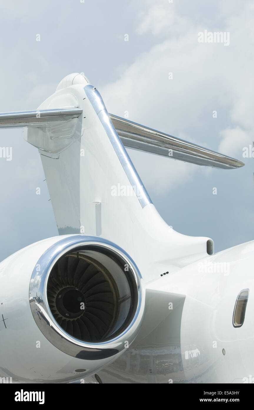 Tail plane and engine of white corporate jet airplane Stock Photo