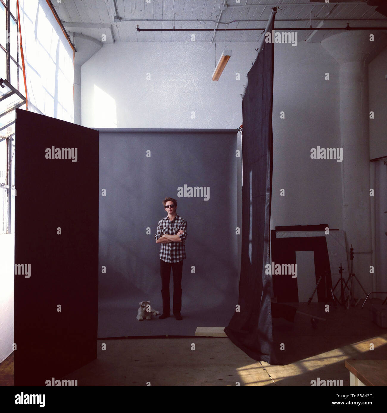 Man posing with dog in studio - Smartphone Captured Stock Image