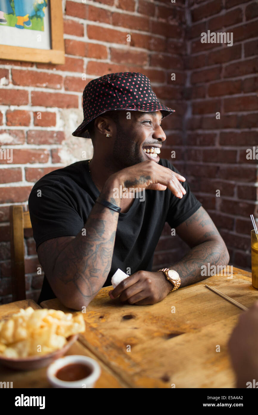 African American man laughing in restaurant Stock Photo