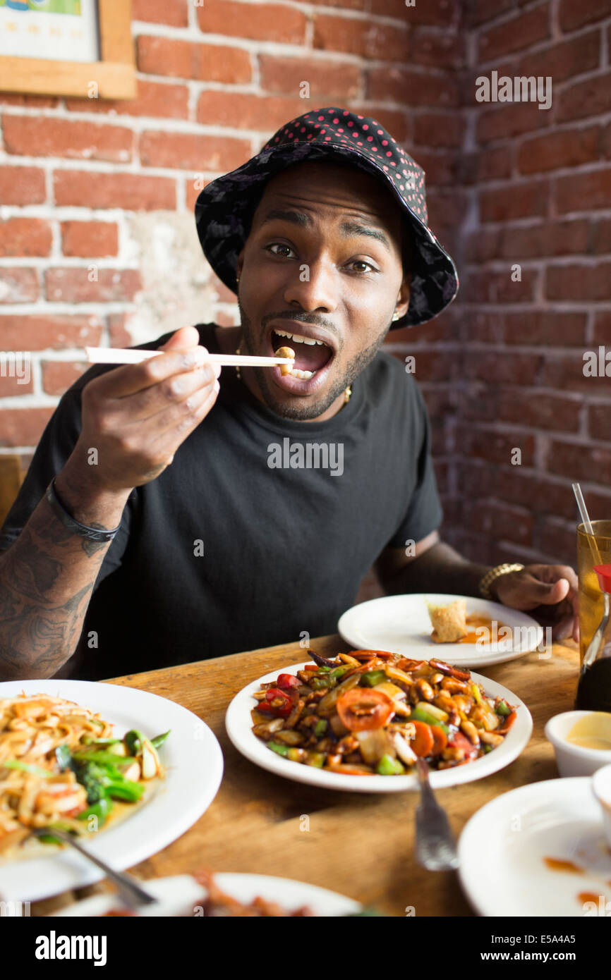 African American man eating at restaurant Stock Photo
